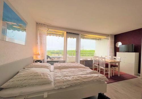 - une chambre avec un lit, une table et une fenêtre dans l'établissement Ferienpark Sierksdorf App 775 - Strandlage, à Sierksdorf