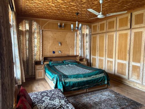 a bedroom with a bed in a room with wooden walls at Taha Inn Home comfort in Srinagar