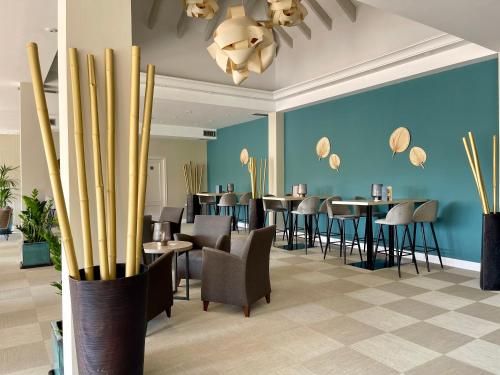 a restaurant with tables and chairs and a blue wall at Wyndham Residences Costa del Sol in Fuengirola