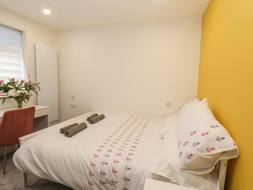 a bedroom with a white bed with white sheets at Frankies Seaview 2 in Bridlington