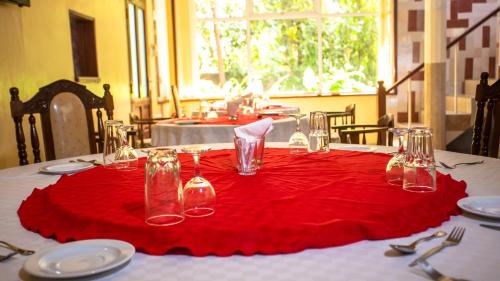 einem Tisch mit einem roten Tischtuch auf einem Tisch in der Unterkunft Hotel Windsor-Mombasa in Mombasa