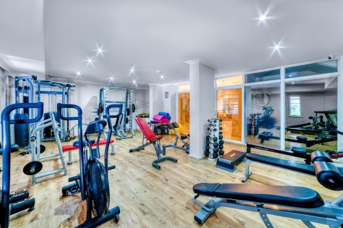 a gym with several treadmills and exercise equipment at Kahya Hotel in Alanya