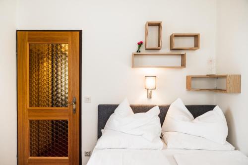 a bedroom with a bed with white pillows at PANORAMA SportHOTEL in Wenigzell