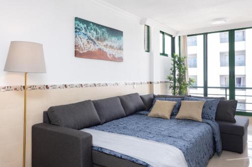 een woonkamer met een bank in een kamer bij Tre spaziosi appartamenti a 150m dal lungomare di Las Americas in Arona