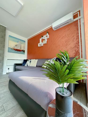 a bedroom with a bed and a plant on a table at Luxury Apartman ASIA Rijeka with SEA VIEW in Rijeka