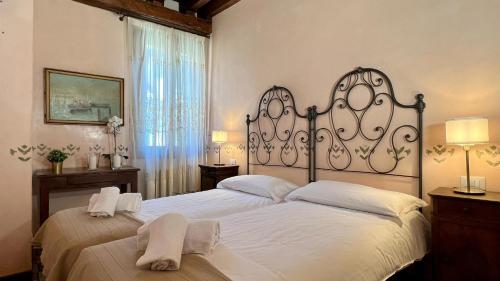 a bedroom with two beds with white sheets at City Apartments Salute-Accademia in Venice