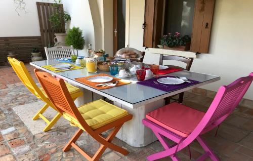 a table with chairs and a table with food on it at B&B Tenuta della Duchessa in Porto Viro