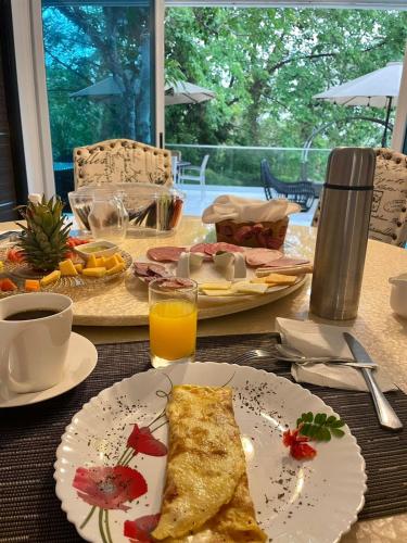 a table topped with a plate of food and orange juice at La Romantica in Contadora