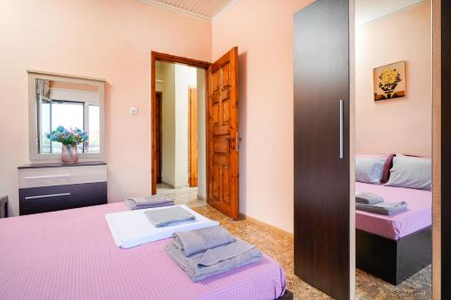 a bedroom with two beds and a mirror at Elia Villa Thassos in Prinos