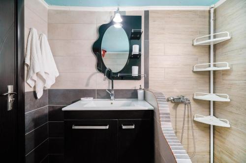 a bathroom with a sink and a mirror at Olivendra Thassos in Prinos