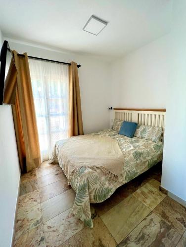 a bedroom with a bed and a window at Cosy, new studio in Costa Adeje in Adeje