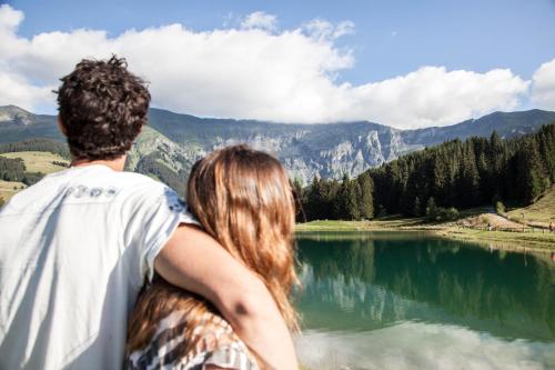 a man and a woman looking at a lake at Mamie Megève in Megève