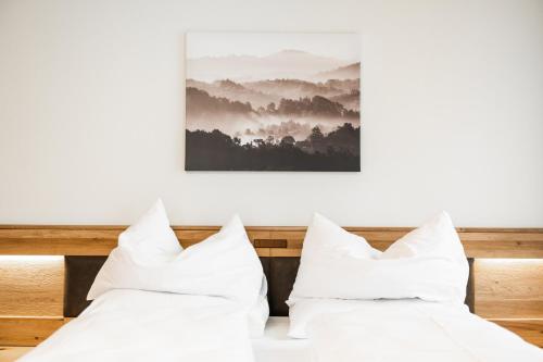 two white pillows sitting on top of a bed at PANORAMA SportHOTEL in Wenigzell