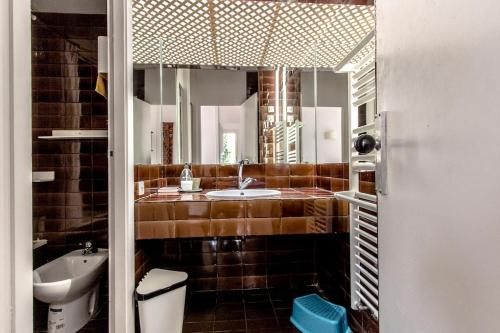 a bathroom with a sink and a toilet and a mirror at Catalunya Casas Rural charm on an olive farm in Costa Dorada! in Vespellá