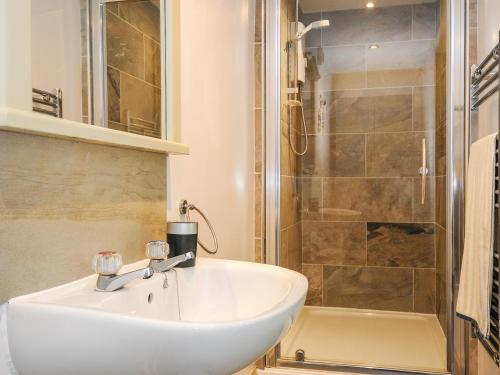 a bathroom with a sink and a shower at Sherwell Farm Annexe in Callington
