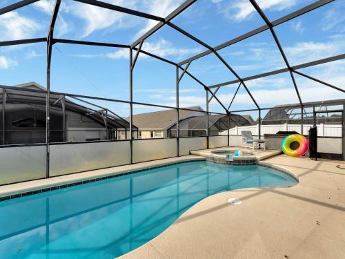 een groot zwembad in een gebouw met een glazen plafond bij key 2 Indian Creek MODERN Pool Home with Game Room NEAR DISNEY in Kissimmee