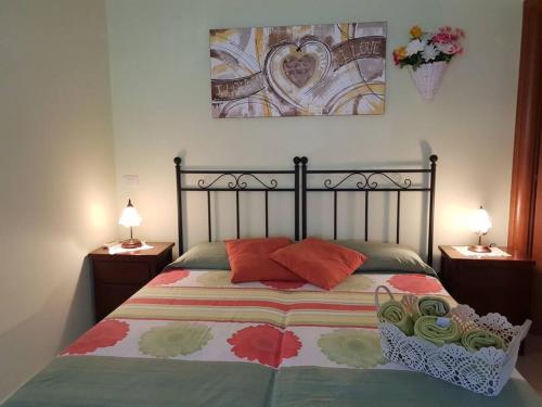 a bedroom with a bed with red pillows on it at Portico Montiferru in Scano Montiferro
