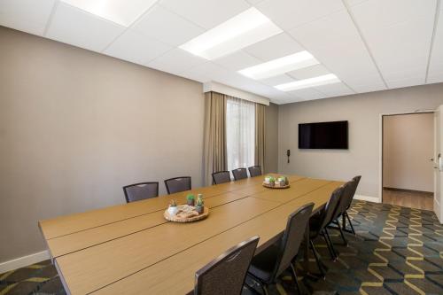a conference room with a large wooden table and chairs at Sonesta ES Suites Dallas Richardson in Richardson