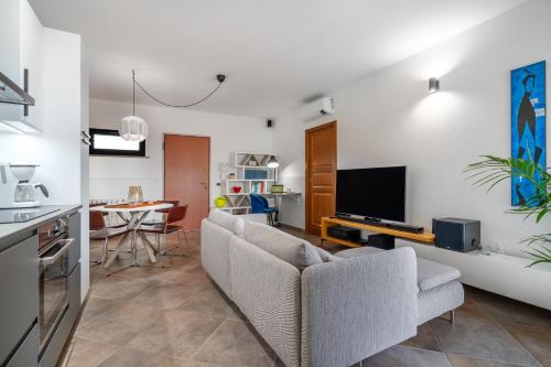 a living room with a couch and a tv at The Park View Place in Olbia
