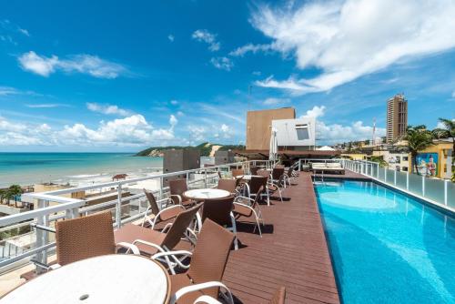 a view of the pool and beach at the resort at DELUX PRAIA Flats in Natal