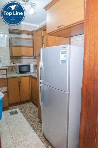 a kitchen with a stainless steel refrigerator in a kitchen at لا يتم الحجز in Alexandria