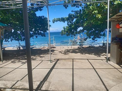 a view of the beach from an open umbrella at Room in Lobo Triple N Homestay 3rd N 