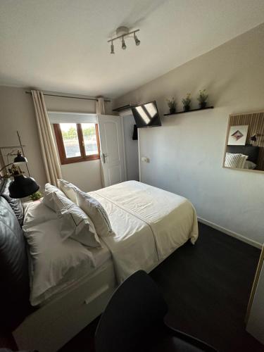 ein Schlafzimmer mit einem weißen Bett und einem Fenster in der Unterkunft Apartamento acogedor en la laguna in La Laguna
