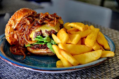 a plate of food with a sandwich and french fries at Fountains Hotel in Cape Town