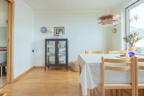 a dining room with a table and chairs at Serenity by the Sea / 3-BR House / Sea View in Syðrugøta