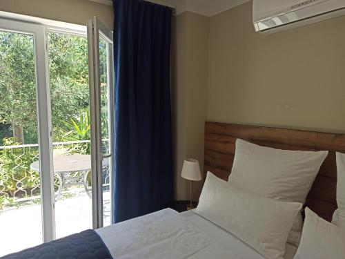 a bedroom with a bed and a sliding glass door at AdriaApart in Sveti Filip i Jakov