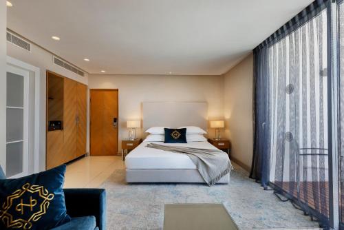 a bedroom with a bed and a couch at Herbert Samuel The Reef Eilat in Eilat