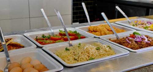 a buffet with several trays of food on a table at Fountains Hotel in Cape Town