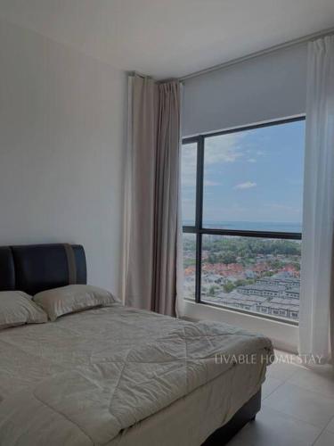 a bedroom with a bed and a large window at Livable Homestay in Sandakan