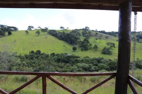 a view of a green hill with trees on it at Estalagem Sensações in Cunha