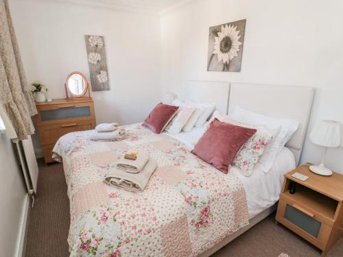 アンブルにあるLighthouse Cottageのベッドルーム1室(ピンクと白の毛布付きのベッド1台付)