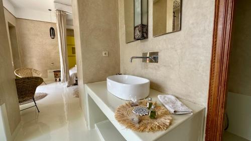 a bathroom with a white sink on a counter at Les Jardins de Kesali in Marrakesh