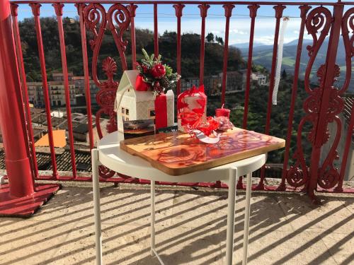 a table on a balcony with a bird house on it at La Vista in Calitri