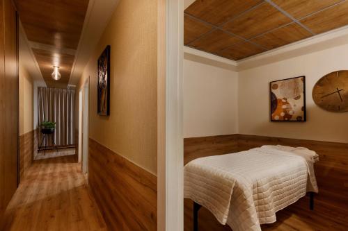 a bedroom with a bed and a clock on the wall at Herbert Samuel The Reef Eilat in Eilat