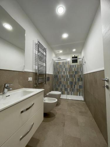 a bathroom with a sink and a toilet and a shower at Appartamento 31 H in Taormina