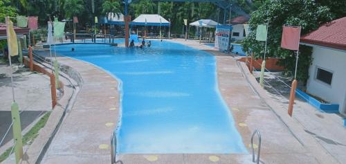a large swimming pool with blue water in a resort at Gallery, air-conditioned room with double bed Bathroom Toilet Pools Beaches around the corner in Gabi