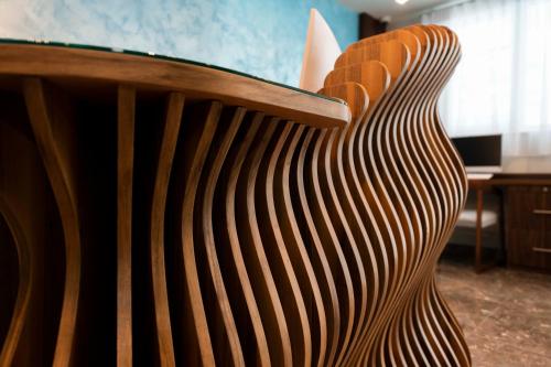 a wooden chair sitting in a room at Antoniel Suites in St Julian's