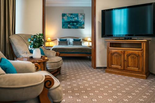 a living room with a large flat screen tv at Hotel Trotuş in Onești