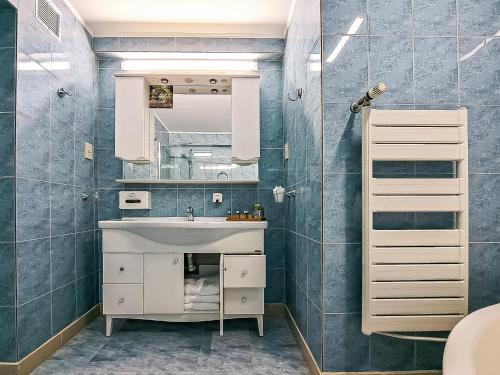 a bathroom with a sink and a mirror at Hotel Trotuş in Onești