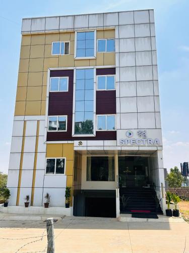 a building with the entrance to a hospital at Spectra Hotel Bangalore Airport in Bengaluru