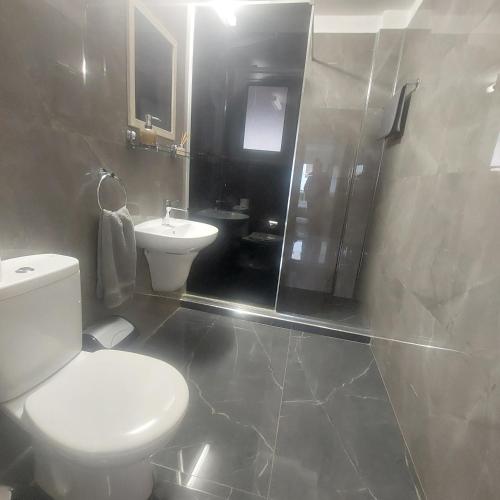 a bathroom with a toilet and a shower and a sink at Modern Studio apartment Armonia Court in Paralimni