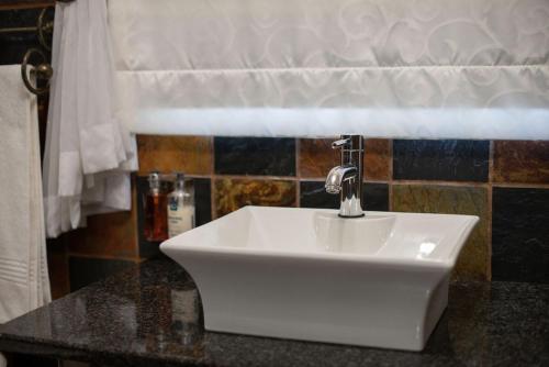 a white sink on a counter in a bathroom at Micasa Sucasa Guesthouse in Lephalale