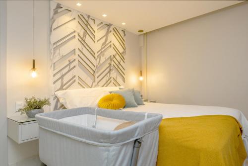 a bedroom with a bed with a yellow blanket at DELUX PRAIA Flats in Natal