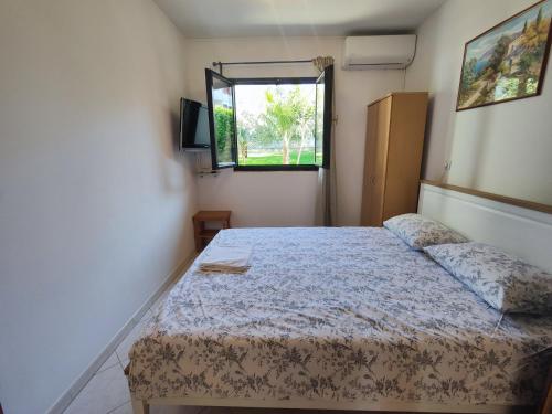 a bedroom with a bed and a window at Apartments Urban Porec in Poreč