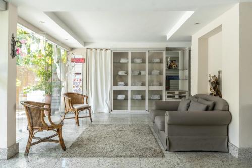 a living room with a couch and a table and chairs at DELUX PRAIA Flats in Natal