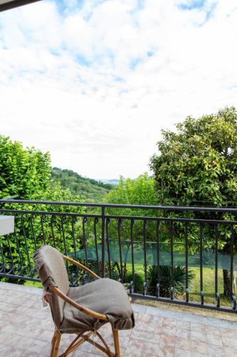 a chair sitting on a balcony with a view at La collina dei nonni - Tarzo in Tarzo